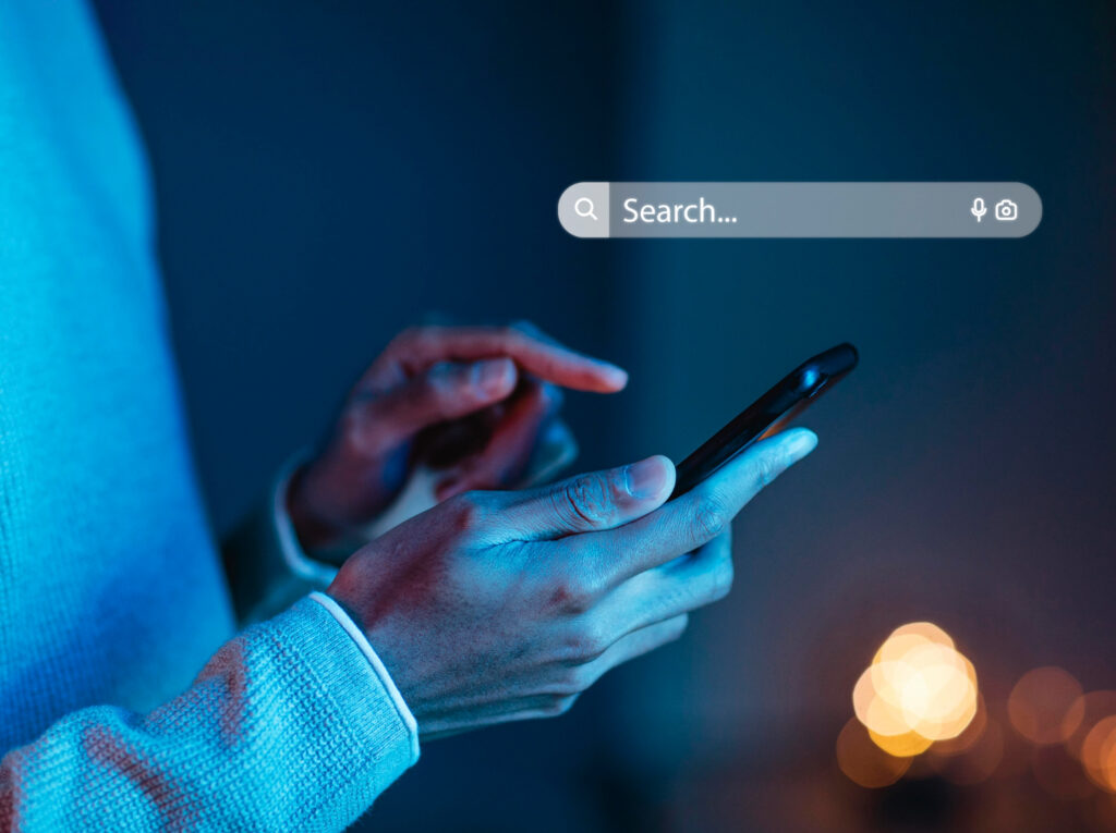 person searching something on mobile phone